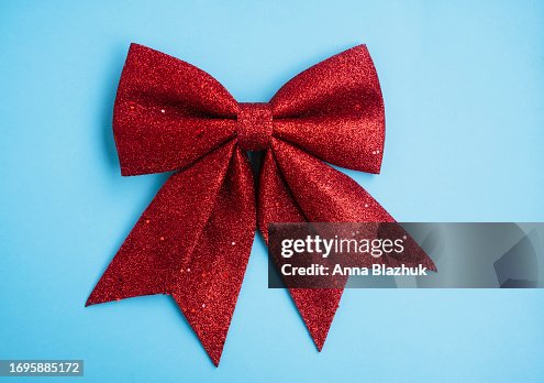 Big Christmas red bow decoration on blue background Big Christmas red bow decoration on blue background