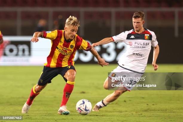 Pontus Almqvist of Lecce competes for the ball with Morten Frendrup of Genoa during the Serie A TIM match between US Lecce and Genoa CFC at Stadio...