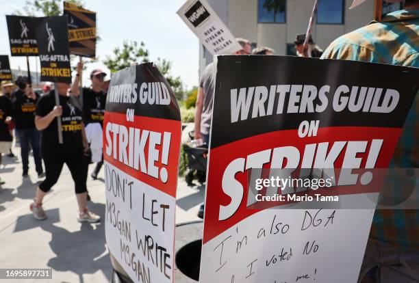 Striking WGA members picket with striking SAG-AFTRA members outside Netflix studios on September 22, 2023 in Los Angeles, California. The Writers...