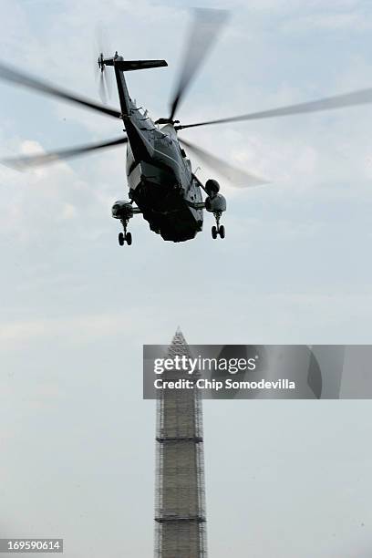 With U.S. President Barack Obama on board, Marine One lifts off the South Lawn and flys past the Washington Monument after departing the White House...