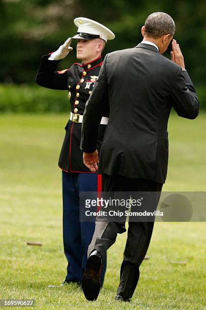 President Barack Obama salutes a Marine before boarding Marine One and departing the White House May 28, 2013 in Washington, DC. Obama is traveling...