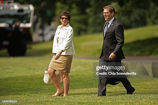 White House Senior Advisor Valerie Jarrett and Press Secretary Jay Carney walk across the South Lawn before departing the White House with U.S....