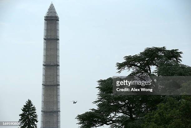 With U.S. President Barack Obama on board, Marine One lifts off the South Lawn and flys past the Washington Monument after departing the White House...