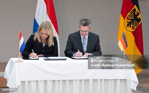 German Defence Minister Thomas de Maiziere and his dutch counterpart Jeanine Hennis-Plasschaert sign a memorandum of understanding on May 28, 2013 at...