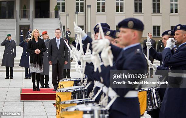 German Defence Minister Thomas de Maiziere and his dutch counterpart Jeanine Hennis-Plasschaert walk along a guard of honour on May 28, 2013 at the...