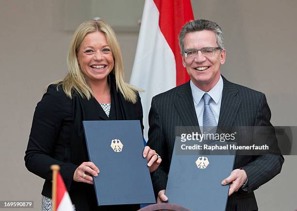 German Defence Minister Thomas de Maiziere and his dutch counterpart Jeanine Hennis-Plasschaert sign a memorandum of understanding on May 28, 2013 at...