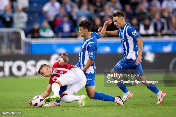 Alex Berenguer of Athletic Club compete for the ball with Ander Guevara of Deportivo Alaves during the LaLiga EA Sports match between Deportivo...