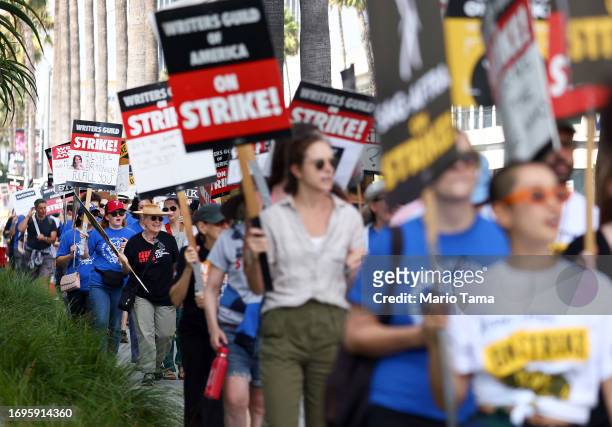 Striking WGA members picket with striking SAG-AFTRA members outside Netflix studios on September 22, 2023 in Los Angeles, California. The Writers...
