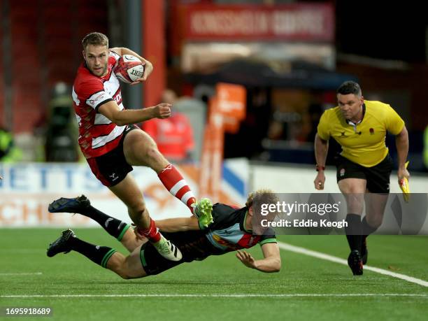 Jake Morris of Gloucester Rugby is tackled by Louis Lynagh of Harlequins during their Premiership Rugby Cup match at Kingsholm Stadium on September...