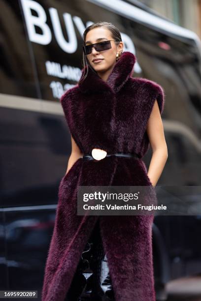 Ginevra Mavilla is seen wearing a black belt, black sunglasses and a bordeaux long sleeveless fur coat outside the Philosophy show during the Milan...