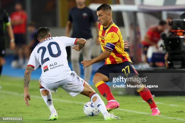 Gabriel Strefezza of Lecce competes for the ball with Stefano Sabelli of Genoa during the Serie A TIM match between US Lecce and Genoa CFC at Stadio...