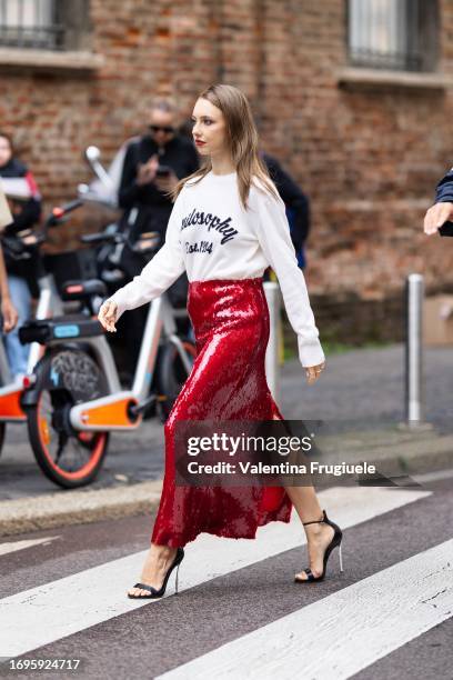 Martina Strazzer is seen wearing a Philosophy white and blue sweater, black heels and a long sequins red skirt outside the Philosophy show during the...