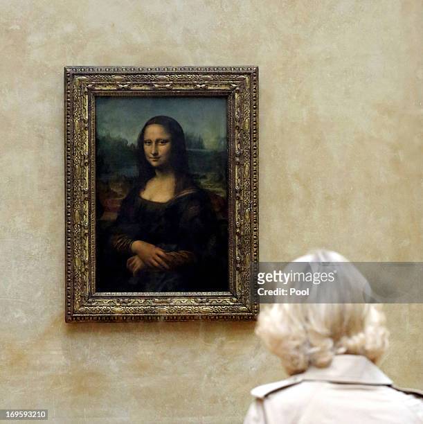Camilla, Duchess of Cornwall views Leonardo da Vinci's Mona Lisa painting as she visits the Louvre Museum on May 28, 2013 in Paris France. Camilla is...