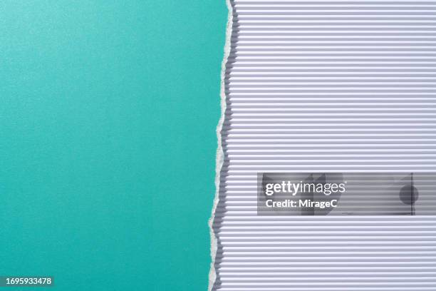 torn turquoise colored paper on white corrugated paper half by half - white construction paper texture stock pictures, royalty-free photos & images
