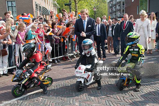 King Willem-Alexander and Queen Maxima of The Netherlands look at small motor bikes during their one day visit to Groningen and Drenthe provinces on...