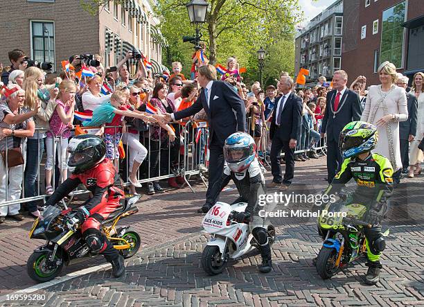 King Willem-Alexander and Queen Maxima of The Netherlands look at small motor bikes during their one day visit to Groningen and Drenthe provinces on...