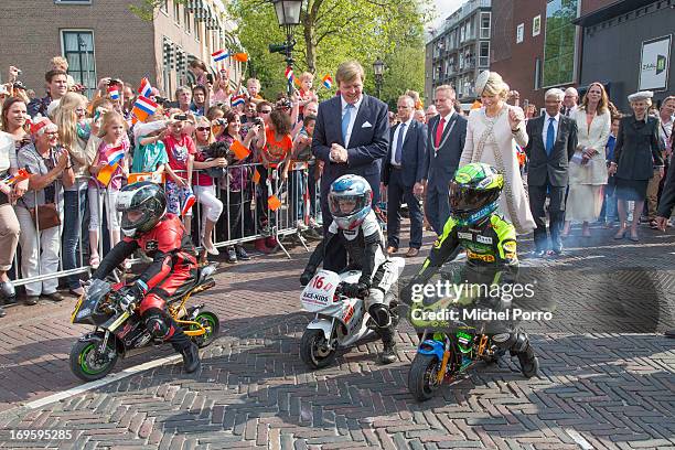 King Willem-Alexander and Queen Maxima of The Netherlands look at small motor bikes during their one day visit to Groningen and Drenthe provinces on...