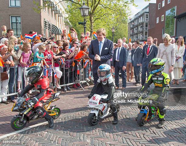 King Willem-Alexander and Queen Maxima of The Netherlands look at small motor bikes during their one day visit to Groningen and Drenthe provinces on...