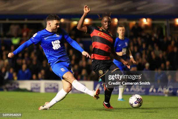 Scott Hogan of Birmingham City shoots under pressure from Osman Kakay of Queens Park Rangers during the Sky Bet Championship match between Birmingham...