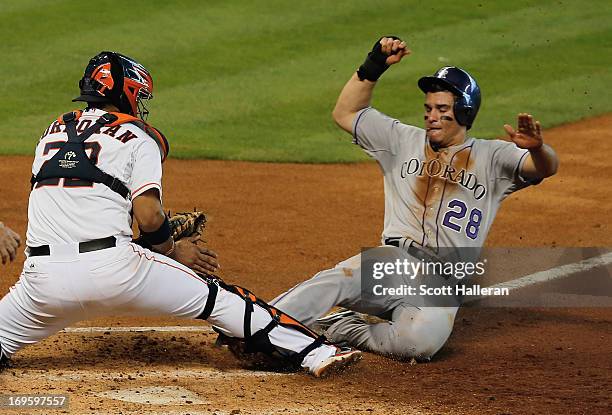 Nolan Arenado of the Colorado Rockies is tagged out at home during the third inning by Carlos Corporan of the Houston Astros at Minute Maid Park on...