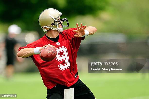 Drew Brees of the New Orleans Saints prepares to throw a pass during OTA's at the Saints training facility on May 23, 2013 in Metairie, Louisiana.