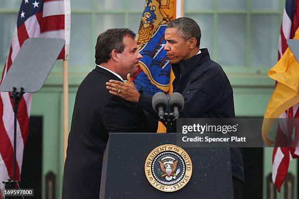 President Barack Obama stands with New Jersey Gov. Chris Christie before speaking to crowds along a rain soaked boardwalk on May 28, 2013 in Asbury...