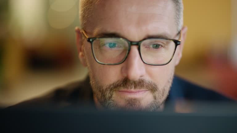 https://media.gettyimages.com/id/1695979805/video/business-man-glasses-and-reading-on-computer-in-programming-software-or-information.jpg?b=1&s=640x640&k=20&c=aXuSSOUJrdlk-PmFGyRVSmqGzbko72BzHTf-JUivEO0=