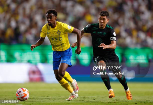 Abdullah Al Khaibari of Al-Nassr Club controls the ball against Roberto Firmino Al-Ahli Club during the Saudi Pro League match between Al- Nassr and...