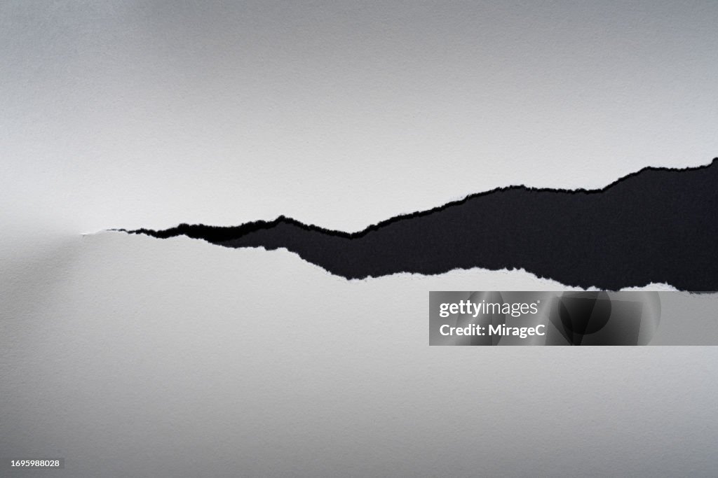 Torn White Paper on Black Background