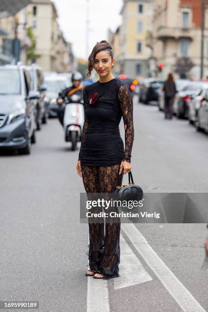 Bettina Looney wears black dress, laced pants, bag outside Philosophy during the Milan Fashion Week - Womenswear Spring/Summer 2024 on September 22,...