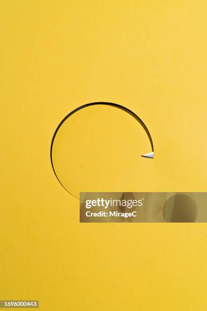 sharp knife cutting a circle shape on yellow paper - organized crime stock pictures, royalty-free photos & images