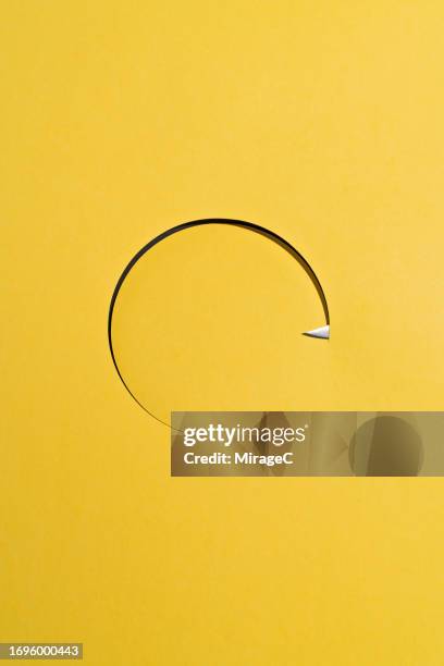 sharp knife cutting a circle shape on yellow paper - thin paper stock pictures, royalty-free photos & images