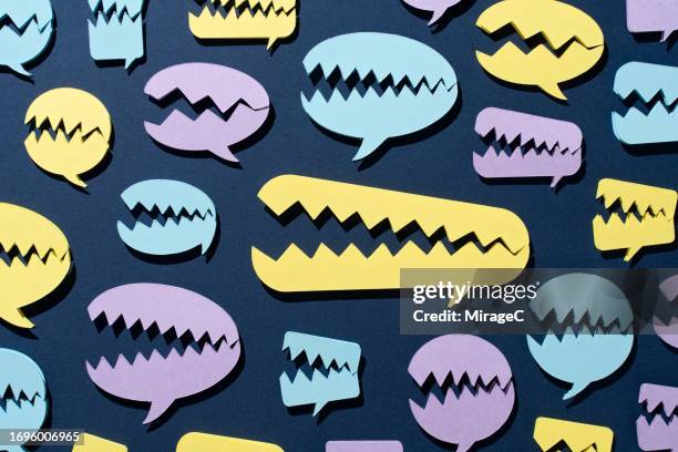 cracked speech bubbles like monsters opening mouths - social media abuse stock-fotos und bilder