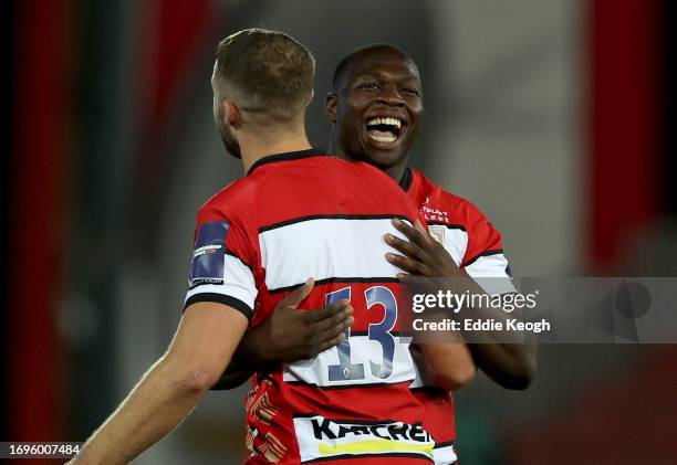 Afolabi Fasogbon of Gloucester Rugby celebrates with Max Llewellyn after beating Harlequins in their Premiership Rugby Cup match at Kingsholm Stadium...