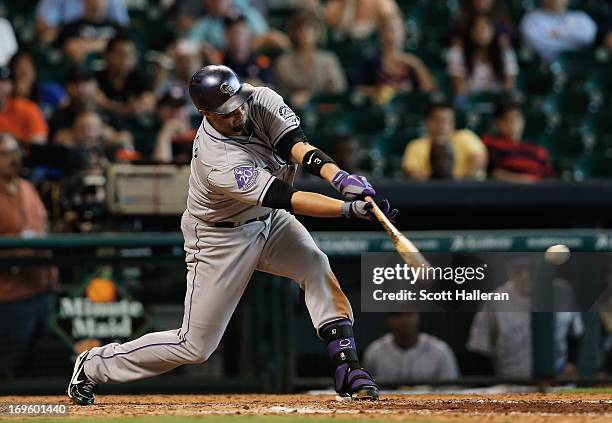 Michael Cuddyer of the Colorado Rockies drives in the go ahead run during the ninth inning against the Houston Astros at Minute Maid Park on May 28,...