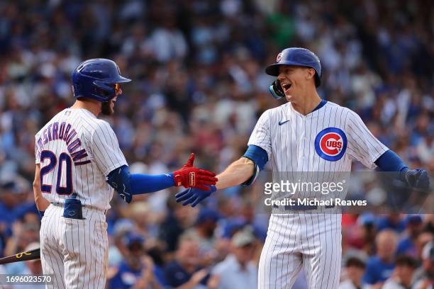 Jared Young of the Chicago Cubs celebrates with Miles Mastrobuoni after hitting a two-run home run against the Colorado Rockies during the sixth...
