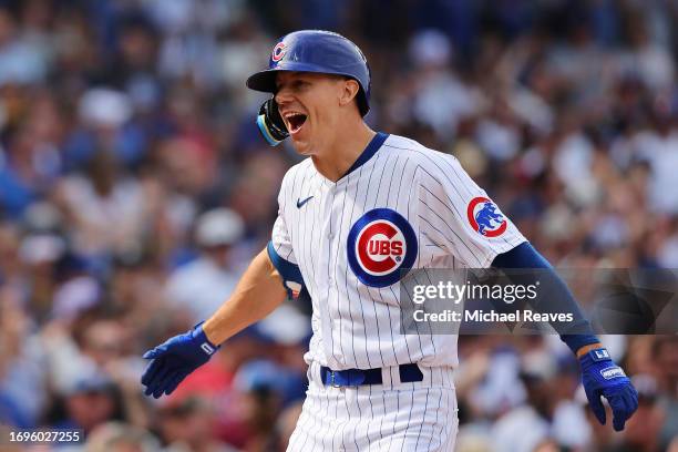 Jared Young of the Chicago Cubs celebrates after hitting a two-run home run against the Colorado Rockies during the sixth inning at Wrigley Field on...