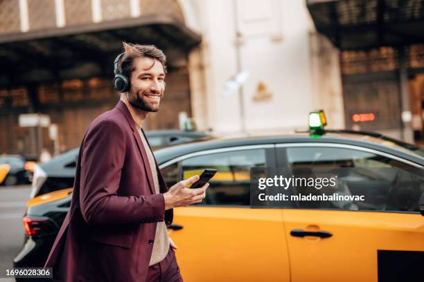 businessman on the city street. - taxi stock pictures, royalty-free photos & images