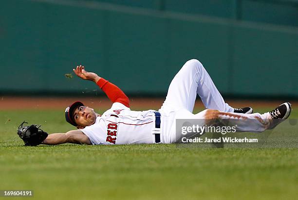 Jacoby Ellsbury of the Boston Red Sox makes a sliding catch in center field against the Philadelphia Phillies during the interleague game on May 28,...
