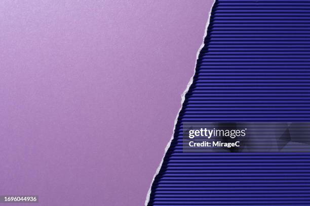 torn purple paper on purple corrugated paper half by half - papel para manualidades fotografías e imágenes de stock
