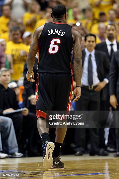LeBron James of the Miami Heat walks back to the bench after he fouled out in the fourth quarter against the Indiana Pacers during Game Four of the...