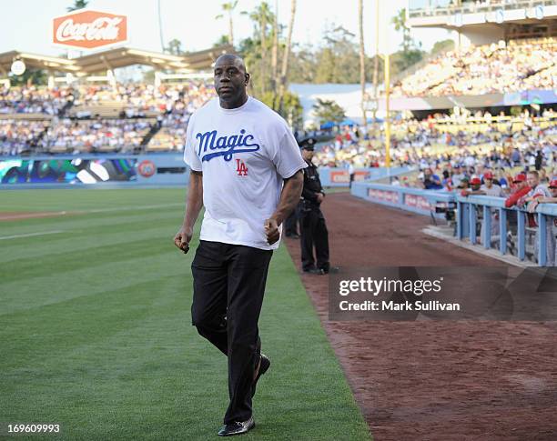 Los Angeles Dodger partner Earvin 'Magic' Johnson on the field during Magic Johnson T-Shirt night before the game between the Los Angeles Dodgers and...