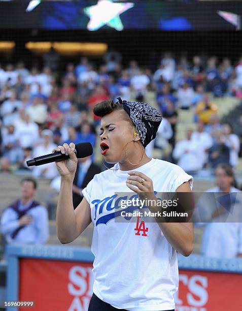 Recording Artist Andra Day sings the national anthem before the game between the Los Angeles Dodgers and the Los Angeles Angels of Anaheim at Dodger...