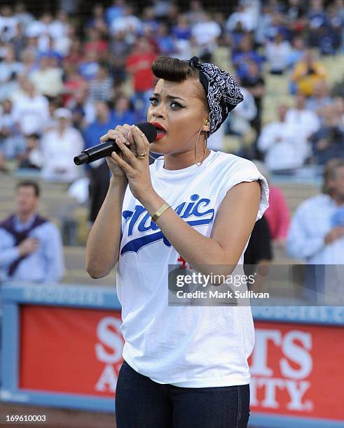 Recording Artist Andra Day sings the national anthem before the game between the Los Angeles Dodgers and the Los Angeles Angels of Anaheim at Dodger...