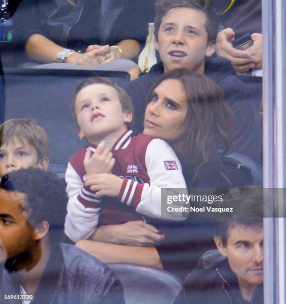 Cruz Beckham and Victoria Beckham attend an NHL playoff game between the San Jose Sharks and the Los Angeles Kings at Staples Center on May 28, 2013...