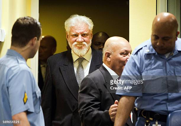 Bosnian Croats Milivoj Petkovic and Slobodan Praljak enter the courtroom May 29, 2013 before their sentencing at the International Criminal Tribunal...