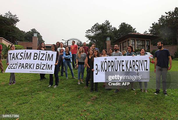 Some twenty students holding a placard reading "We are against a third bridge" stage a protest during the opening ceremony of the third Bosphorus...