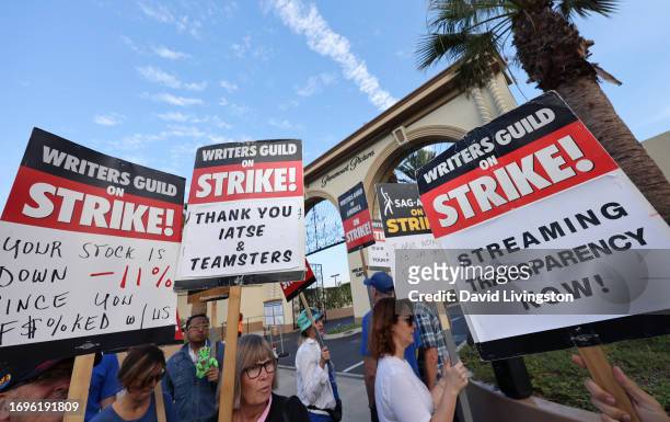 Picketers walk the picket line outside Paramount Studios on September 22, 2023 in Los Angeles, California. Members of SAG-AFTRA and WGA have both...