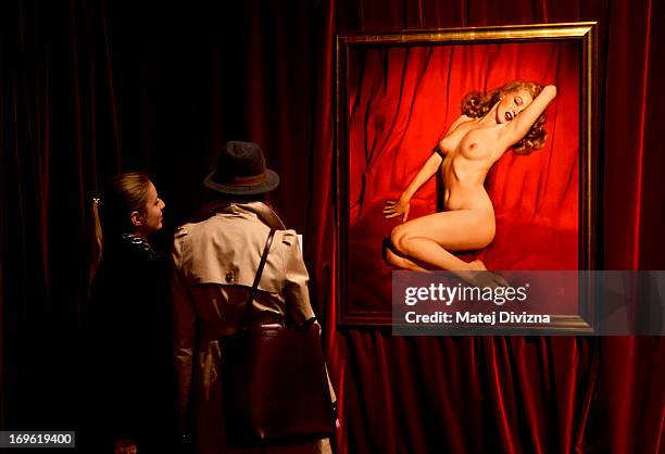 Visitors look at a photo of Marilyn Monroe taken by Tom Kelley in 1949, displayed at the 'Marilyn' exhibition at Prague Castle on May 29, 2013 in...