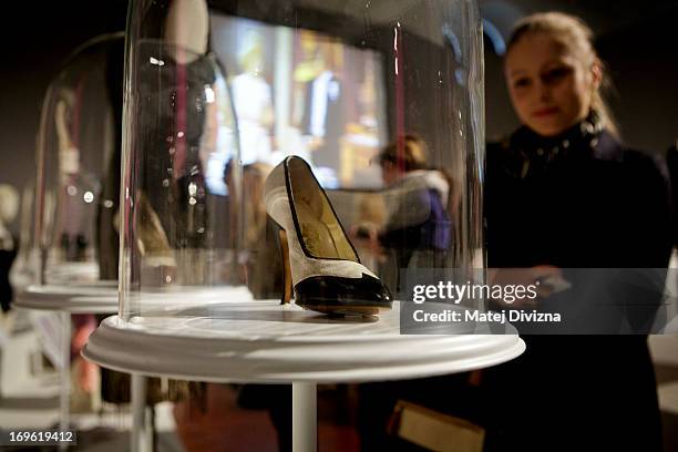 Visitor looks at the high heel shoe designed by Ferragamo from the film 'Some like it hot', during a press preview of the 'Marilyn' exhibition at...